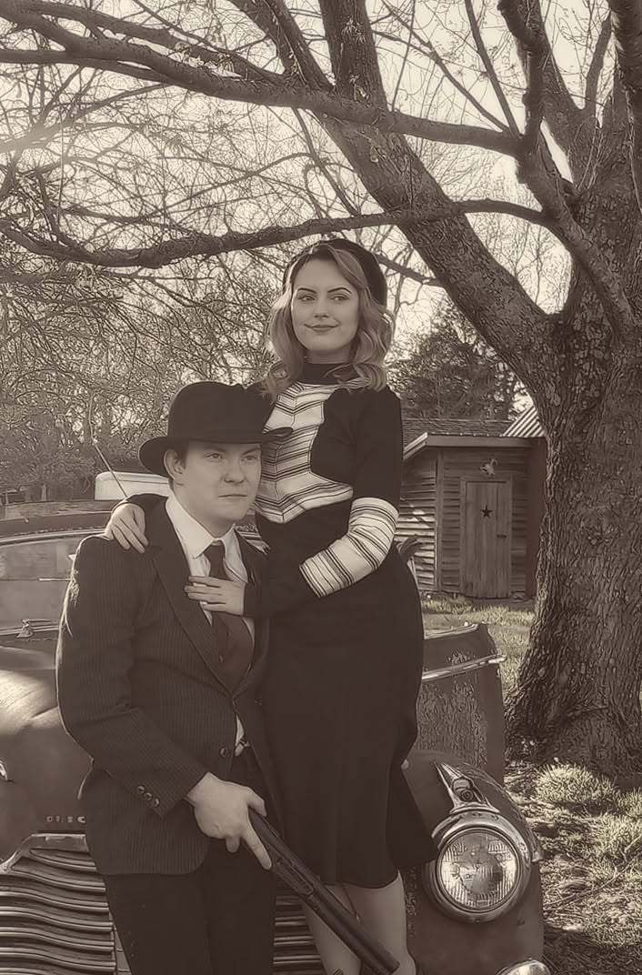 Bonnie and Clyde in front of the vintage Buick, closer view (sepia)