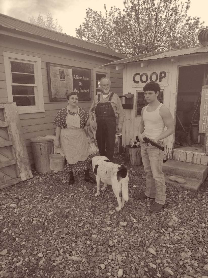 Three cast members and a spotted dog outside the chicken coop (sepia)