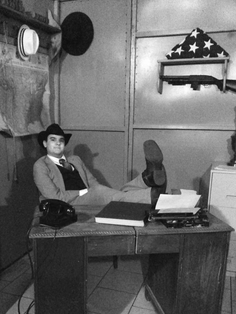 The marshal leaning back with his boots on the office desk (black and white)