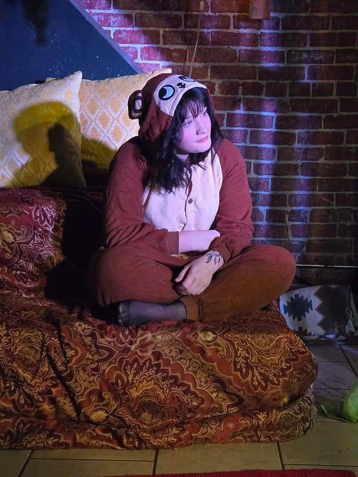 The monkey-suited Abu sits cross-legged on the palace couch in Twisted
