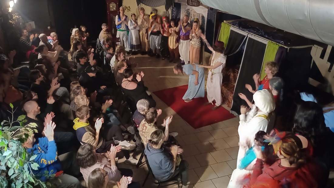 Two performers bow hand in hand at the Twisted curtain call