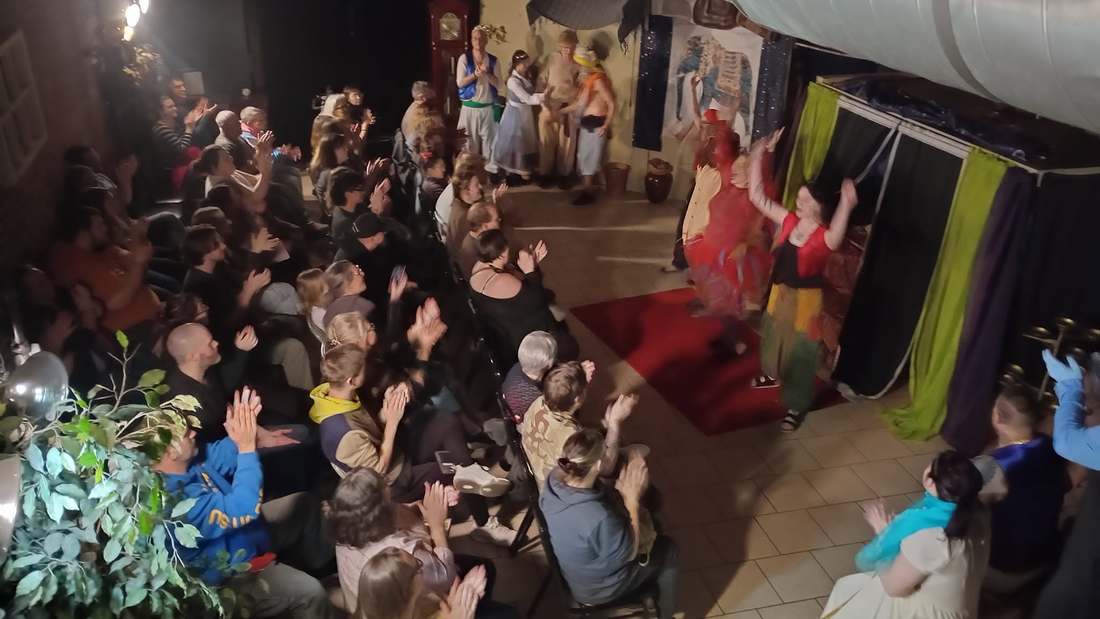Dancers in red take their curtain call bows in Twisted