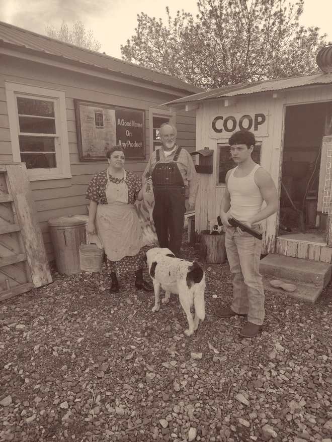 Three cast members and a spotted dog outside the chicken coop (sepia)