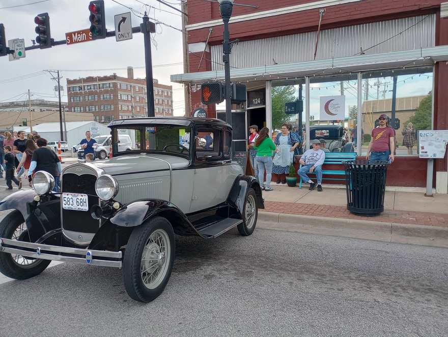 A vintage Ford Model A parked outside the Dream Theatre studio at 124 South Main during the Bonnie & Clyde run