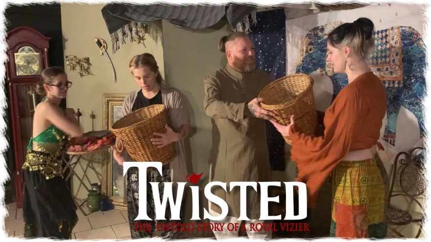 Twisted promo photo — marketplace players pass woven baskets on the set