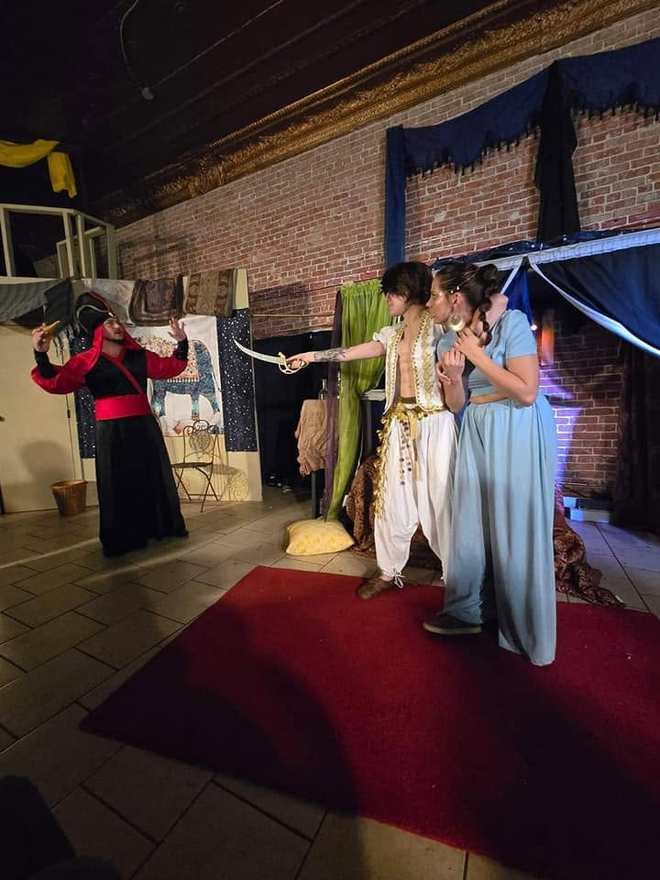 A standoff — the Vizier and the prince point each other down across the red carpet in Twisted