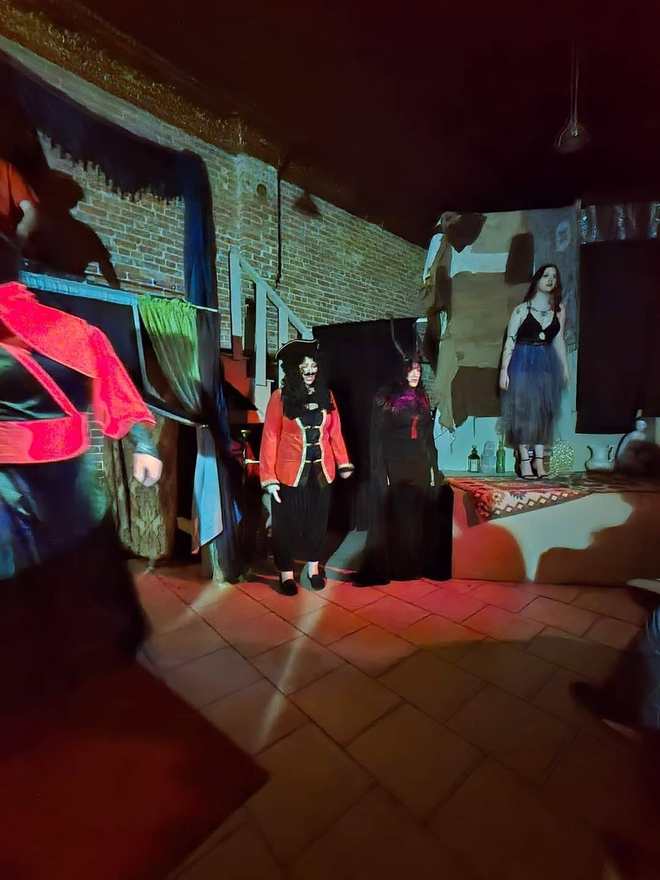 The villains assemble on the platforms under red light in Twisted