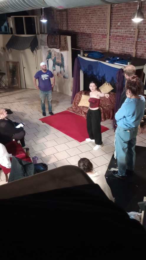 Performers work a scene on the red carpet during Twisted rehearsal