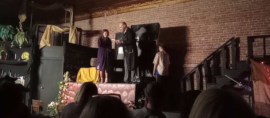 Two performers meet center stage on the stone platform