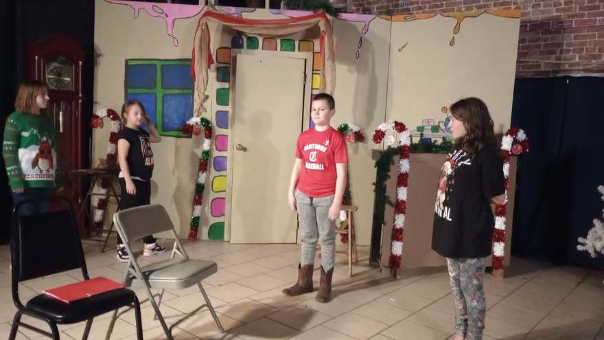 Young performers open the show on the holiday set, with its candy-cane pillars and decorated doorway