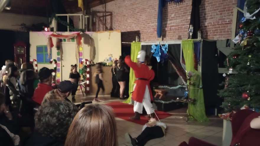 The Nutcracker raises his arm in triumph over the fallen mouse