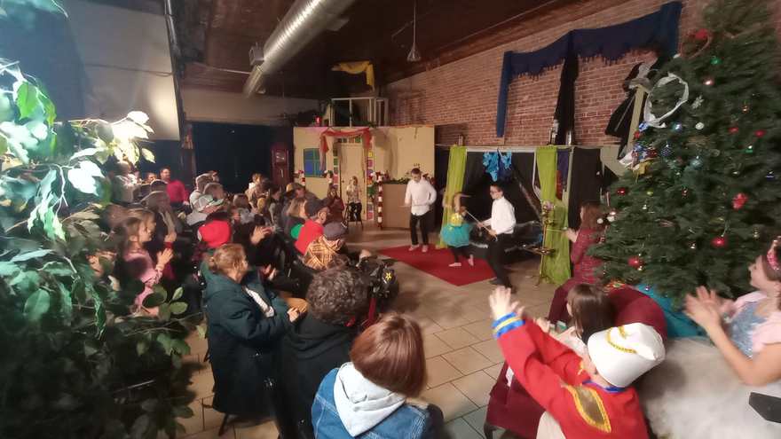 Families applaud from their seats as the performers take the stage