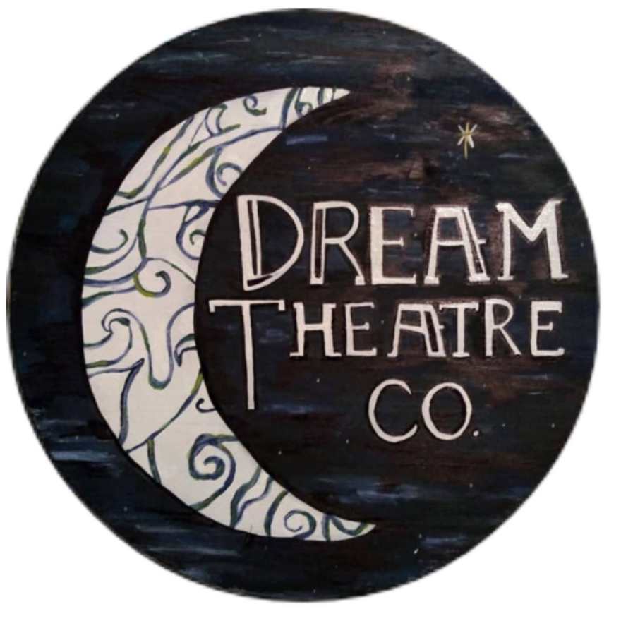 Hand-painted round Dream Theatre Co. sign — a white crescent moon with green swirls against a dark night sky, with the words “Dream Theatre Co.”